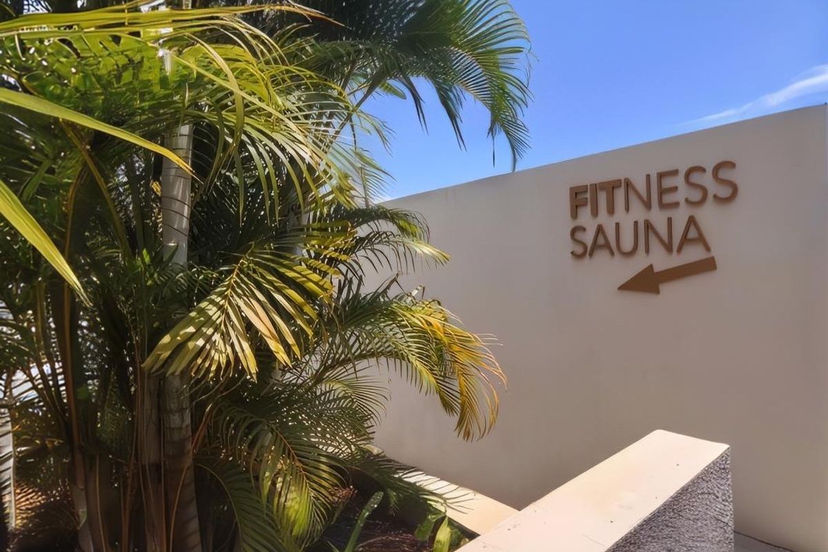Directional signage for the fitness and sauna facilities located within the apartment complex grounds.