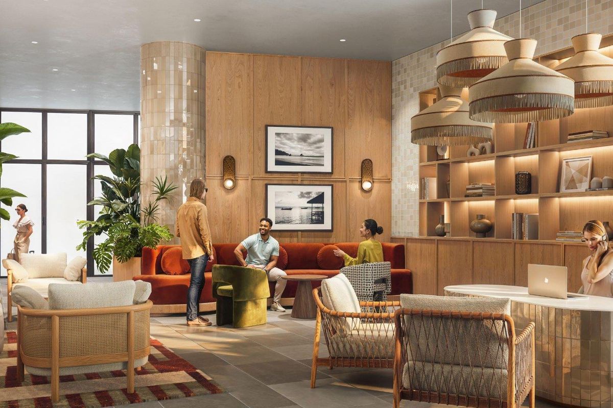 A modern, well-appointed communal lounge area featuring wood-paneled walls, tiled columns, built-in shelving, and stylish pendant lighting.