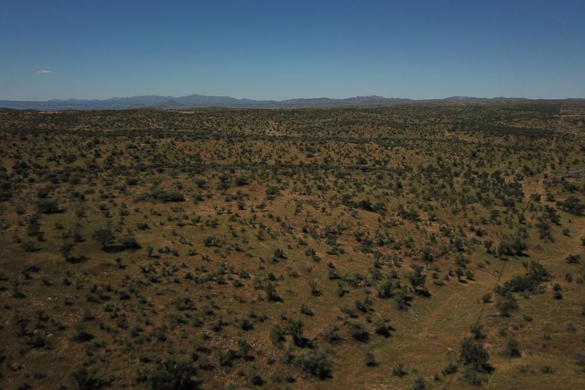 An expansive aerial view of the vacant residential land, showcasing the natural landscape and surrounding terrain.