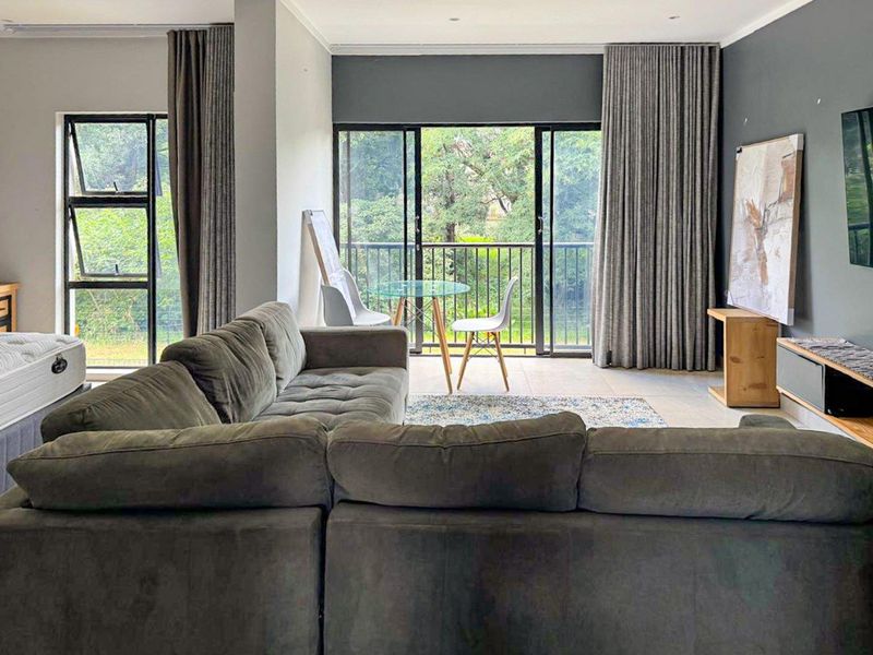 Spacious living area featuring large sliding glass doors that provide natural light and direct access to a private balcony.