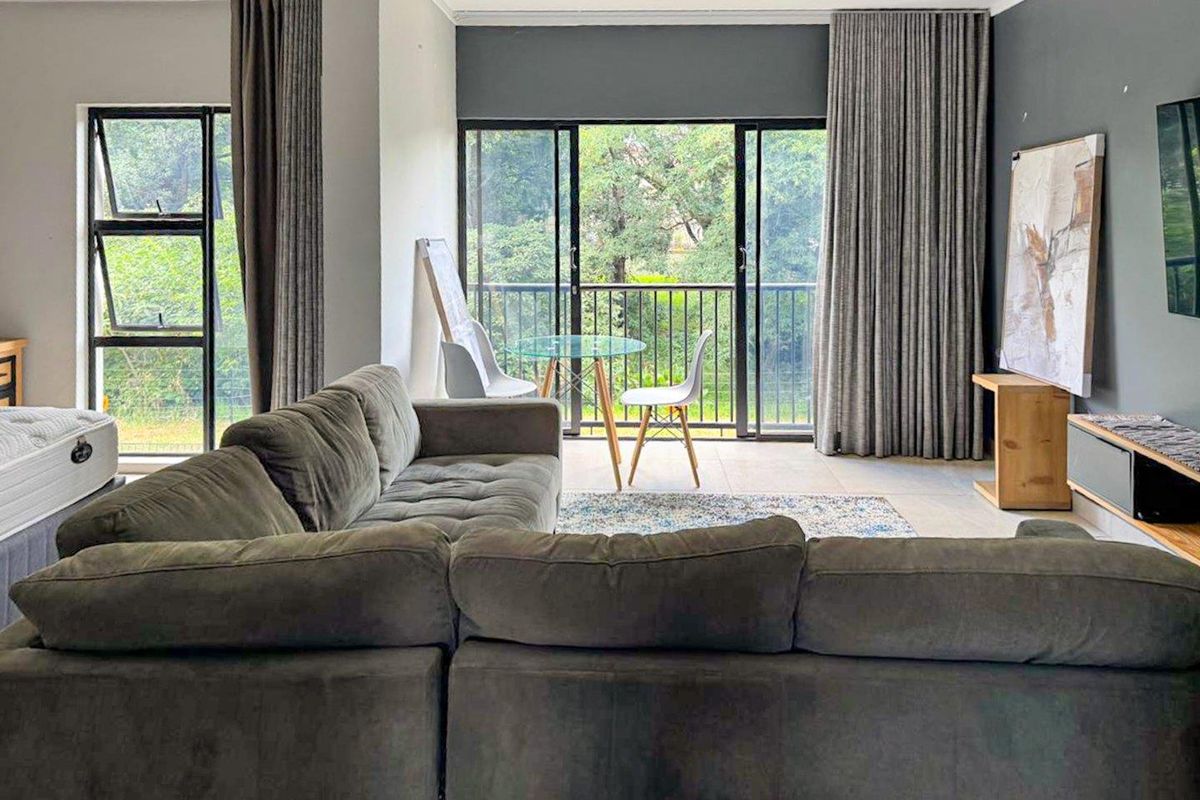 Spacious living area featuring large sliding glass doors that provide natural light and direct access to a private balcony.
