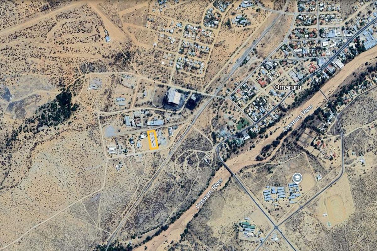 Aerial view of the commercial vacant land plot highlighted in yellow, situated within the Omaruru area near the riverbed.