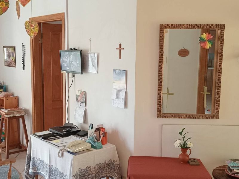 A functional hallway featuring tiled flooring and traditional wooden door frames, providing access to multiple rooms within the home.