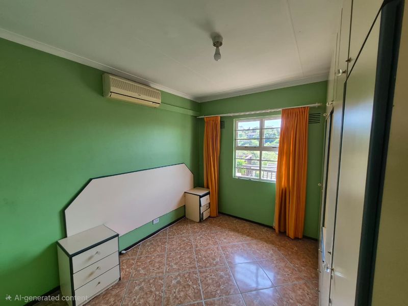 A bedroom featuring tiled flooring, built-in cupboards, and a wall-mounted air conditioning unit, offering a functional space with natural light.