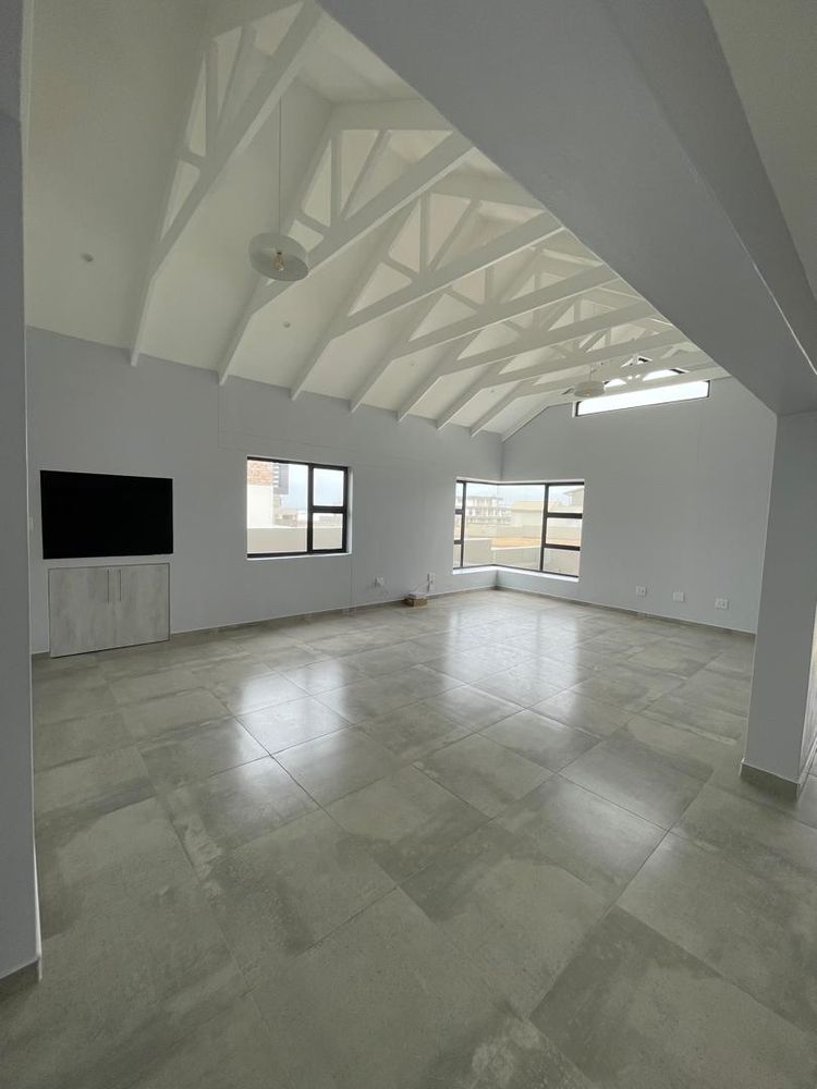 Open-plan lounge/dining area with indoor BBQ