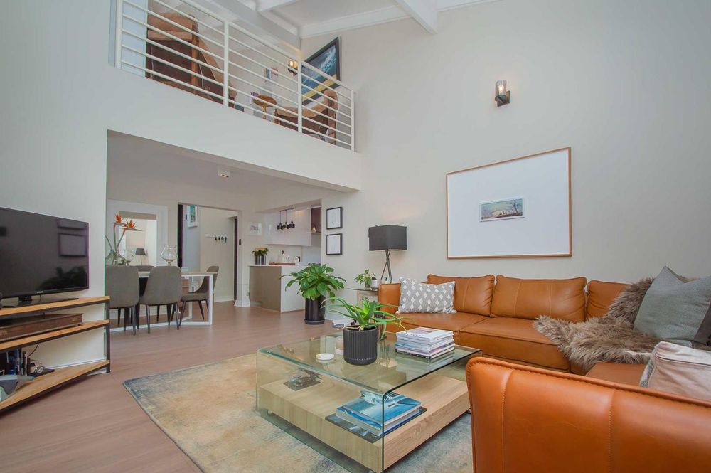 Lounge with double volume ceiling and loft study