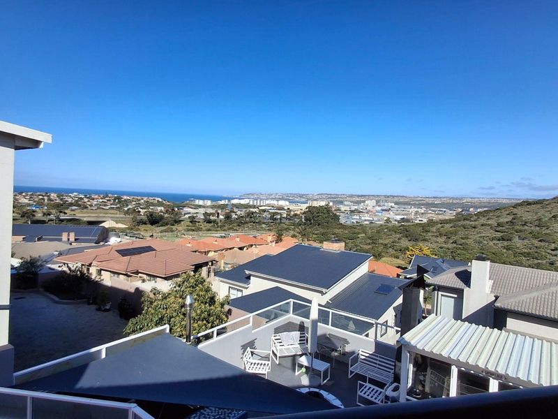 Elevated panoramic view overlooking the surrounding residential neighbourhood and distant coastline.