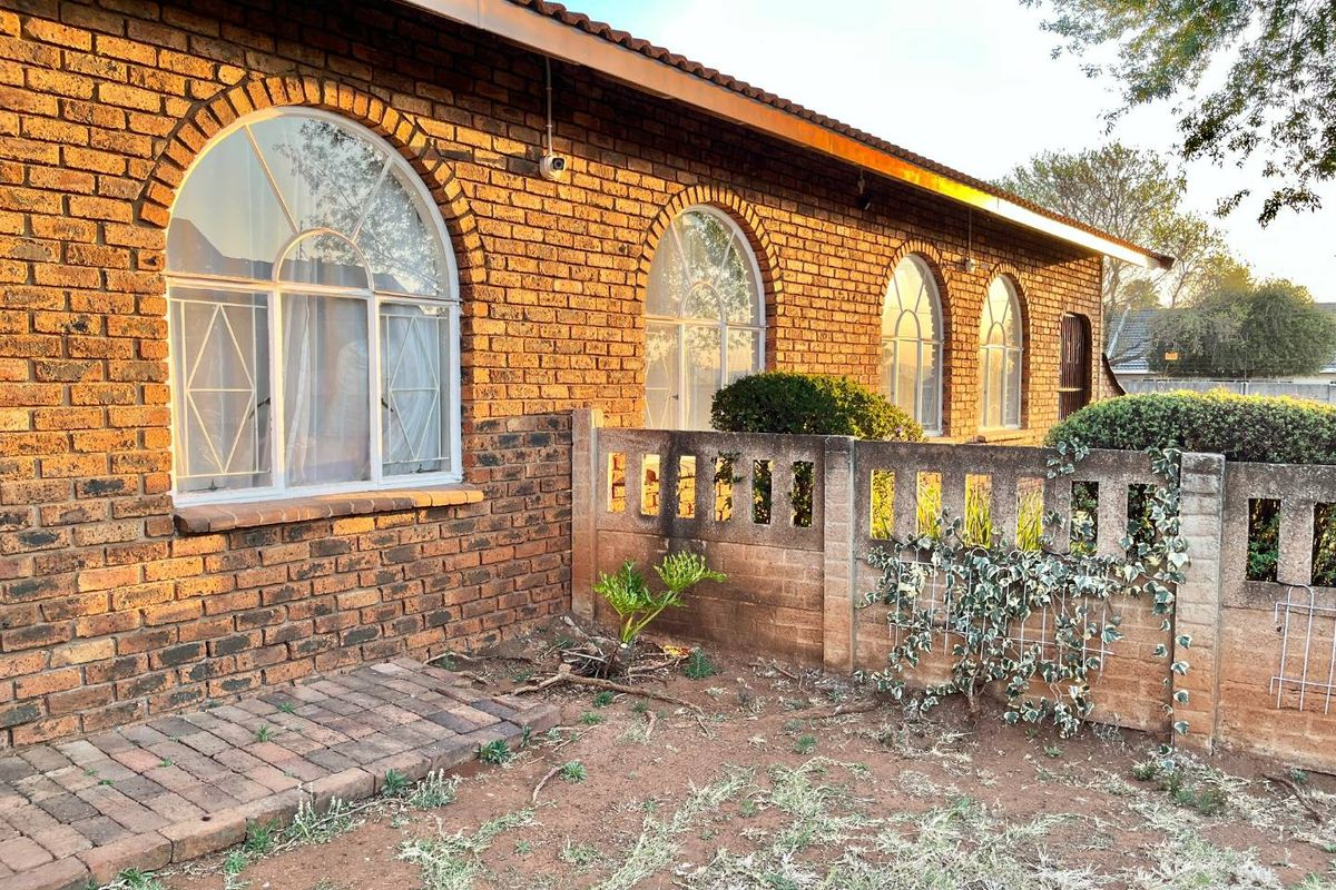 "Elegant Face Brick Home with Modern Security and Ample Parking! - Photo 2