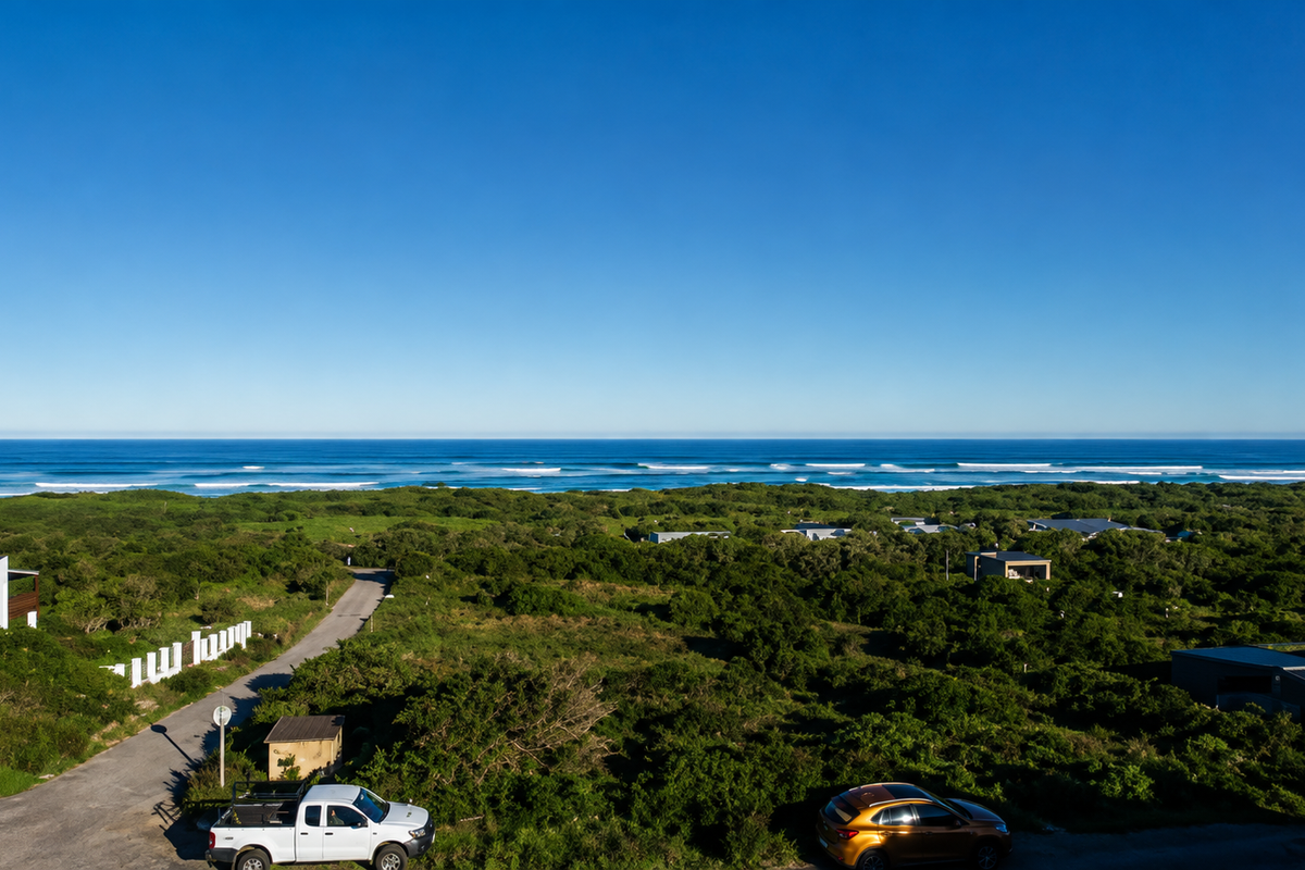 A scenic elevated view overlooking the coastal landscape and ocean, showcasing the natural surroundings of the residential area.
