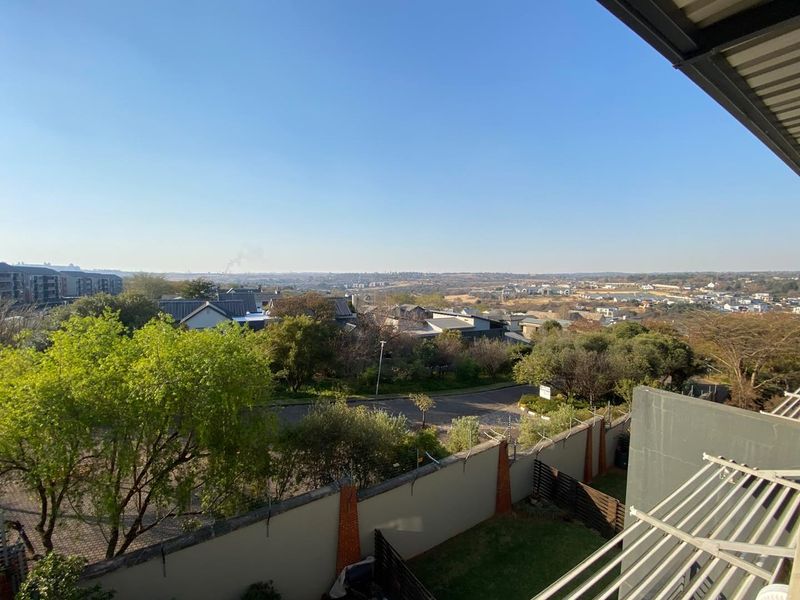 Elevated panoramic view overlooking the surrounding residential neighbourhood and landscape, captured from an apartment balcony.