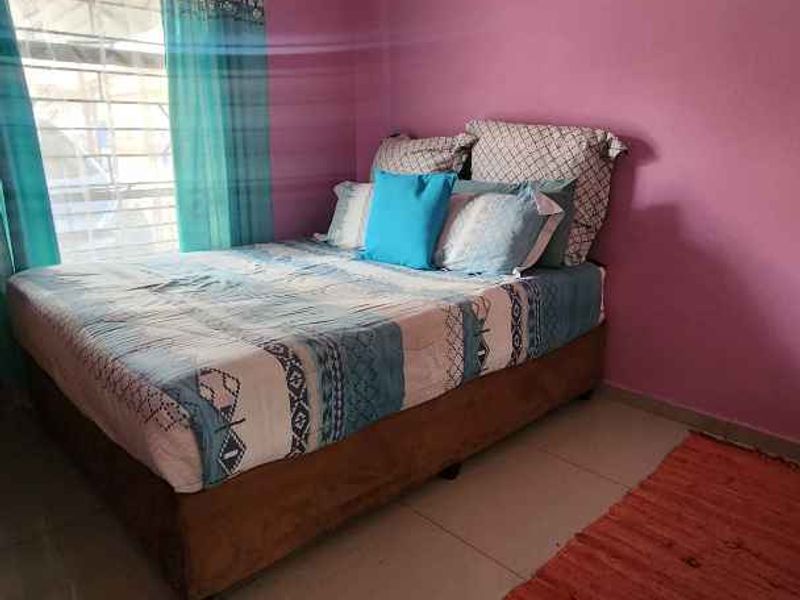 A bedroom featuring tiled flooring and cove cornice detailing.