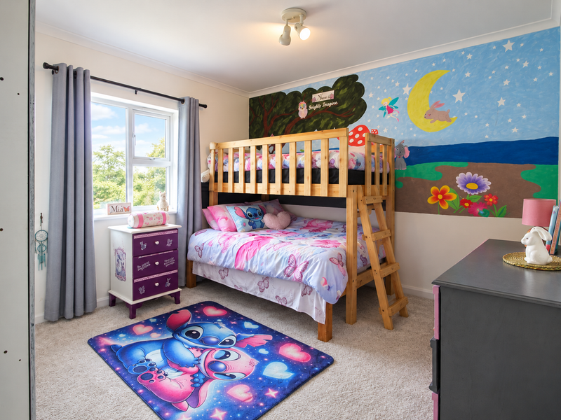 A well-maintained bedroom featuring neutral carpeting, a built-in wardrobe, and a large window providing natural light.
