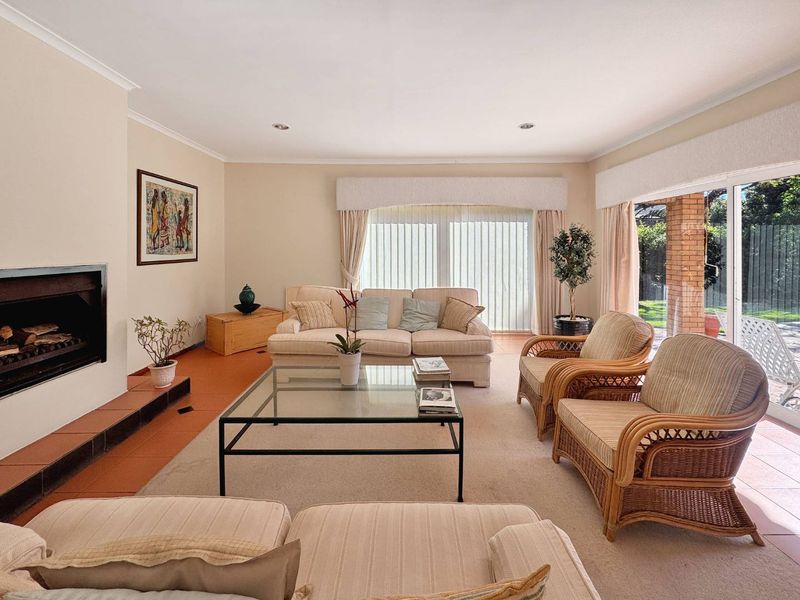 Spacious living room featuring a built-in fireplace with tiled hearth, recessed lighting, and large sliding glass doors providing access to the outdoor area.