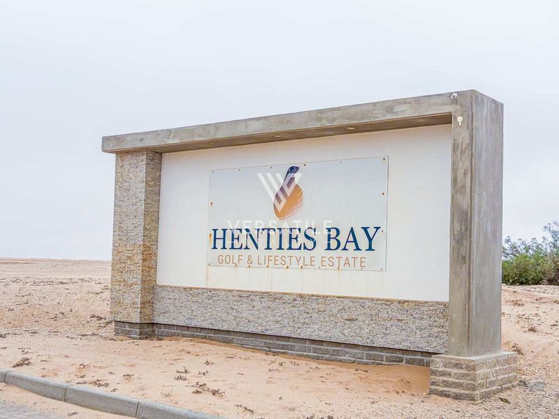 Entrance signage for Henties Bay Golf & Lifestyle Estate featuring stone cladding and concrete construction.