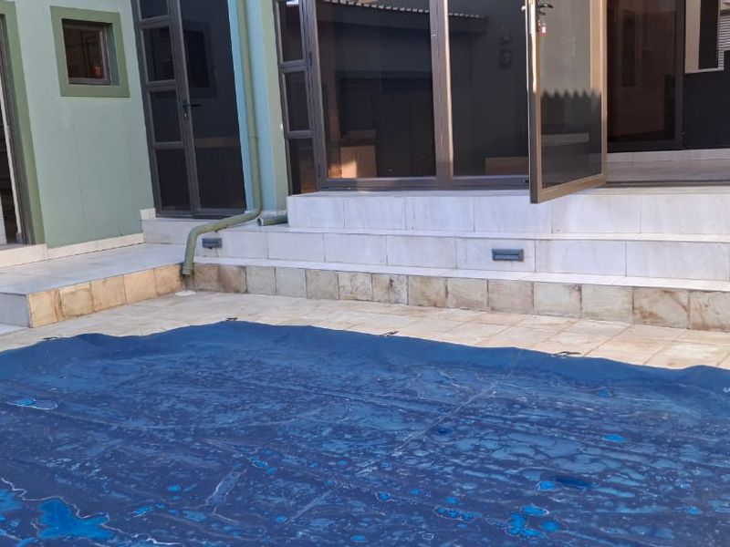 Outdoor pool area featuring a tiled patio, recessed lighting, and direct access to the home through sliding glass doors.