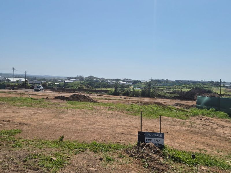 A vacant residential plot of land featuring open ground and boundary fencing, situated in a developing neighborhood.