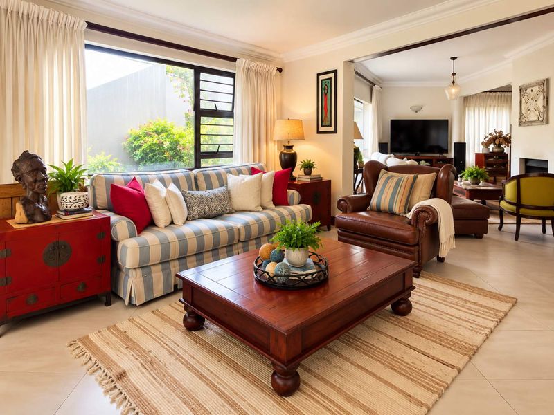 Spacious open-plan living area featuring tiled floors, large windows for natural light, and a cozy fireplace, creating a warm and inviting atmosphere.