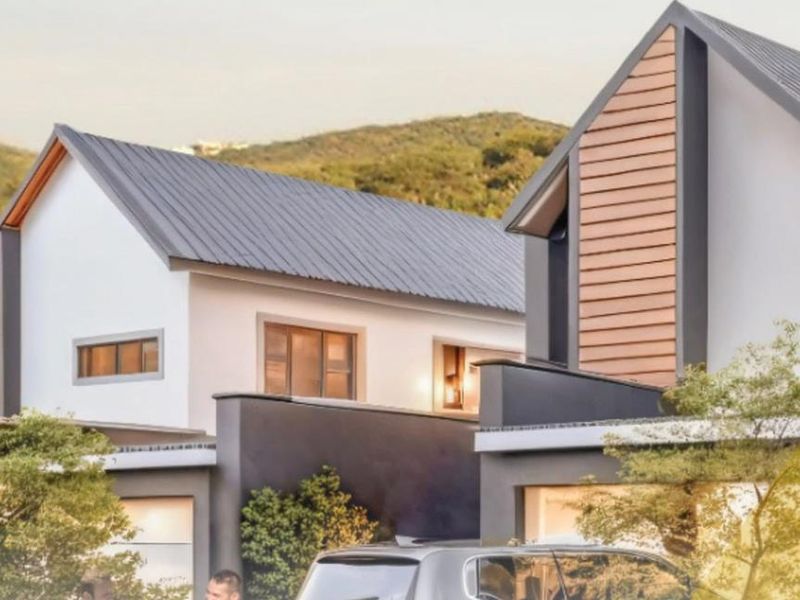 Modern townhouse exterior featuring contemporary architectural design, pitched metal roofing, and clean facade finishes in a scenic setting.