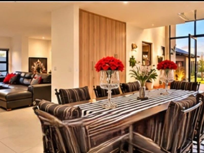 Spacious open-plan living and dining area featuring large glass doors that provide seamless access to the outdoor space and abundant natural light.