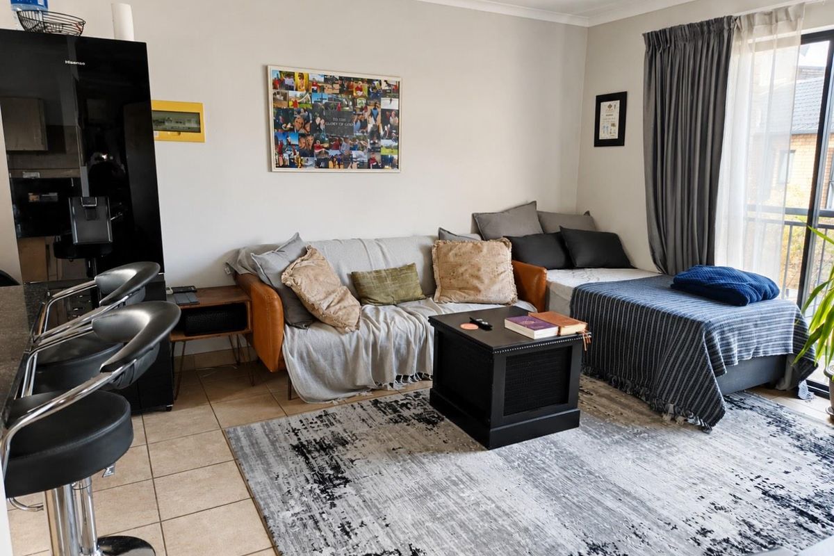 Open plan living area featuring tiled flooring and a sliding glass door leading to an outdoor space.