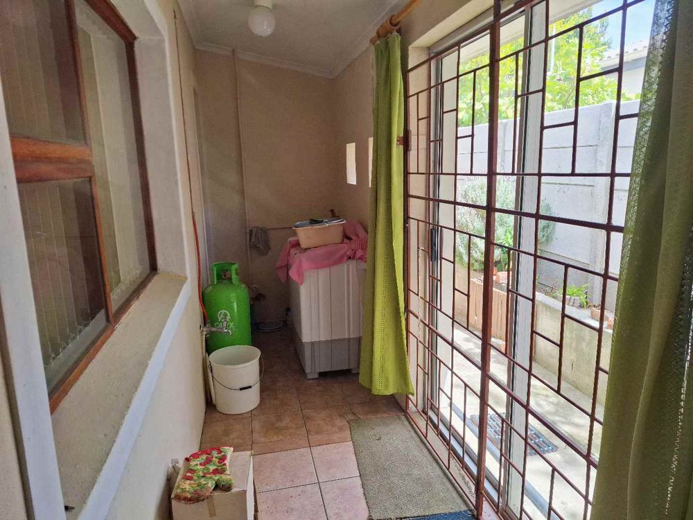 Enclosed area behind kitchen with plumbing for washing machine or dishwasher 