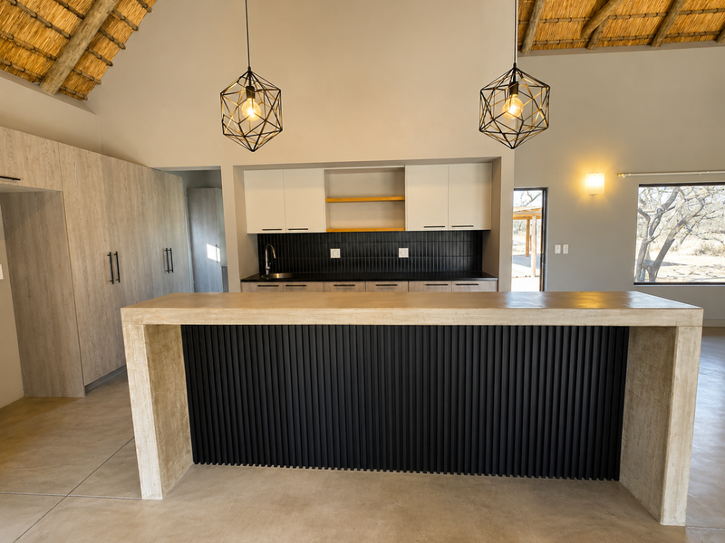 Modern kitchen featuring a large island with slatted detailing, sleek cabinetry, tiled backsplash, and a striking vaulted thatched ceiling.