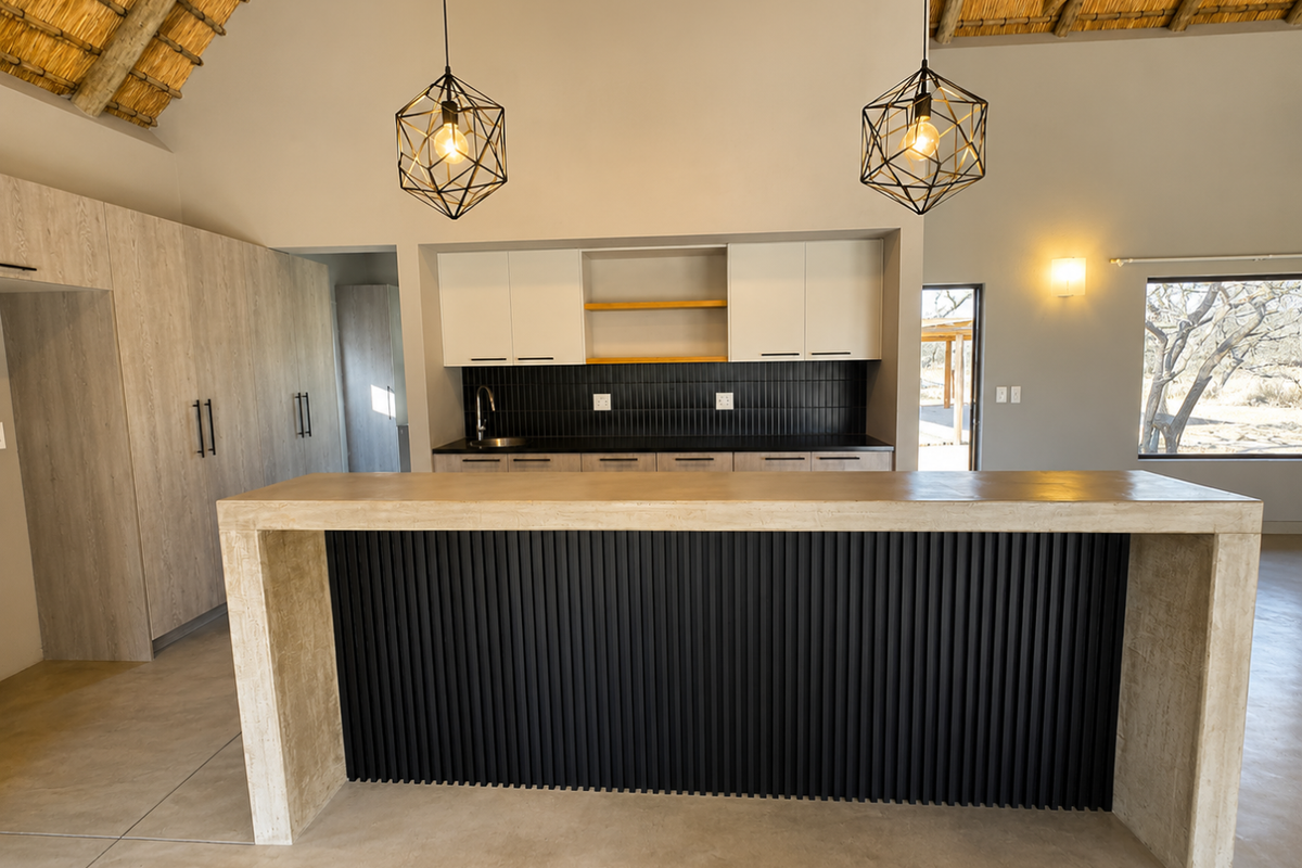 Modern kitchen featuring a large island with slatted detailing, sleek cabinetry, tiled backsplash, and a striking vaulted thatched ceiling.