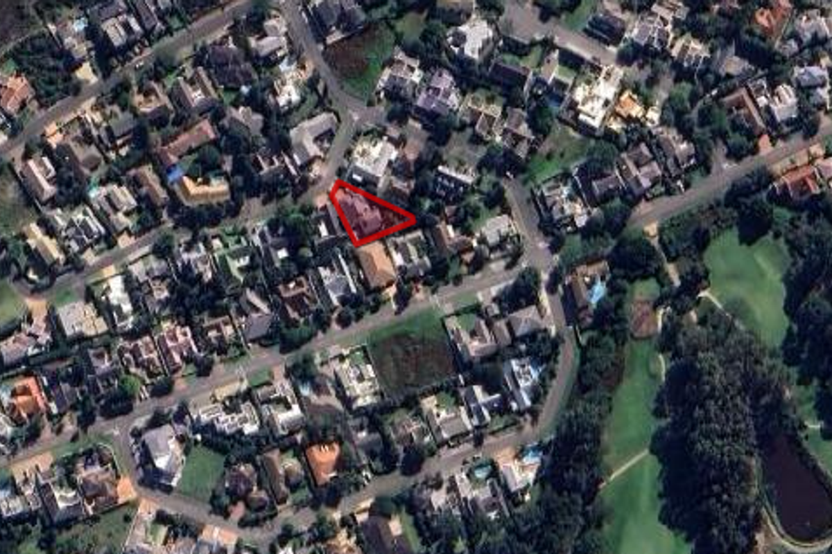 Aerial view of the property located within a residential estate, highlighting its position and surrounding neighborhood layout.