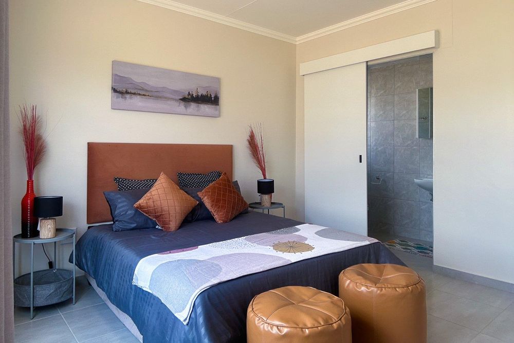 Spacious main bedroom with built-in cupboards and ensuite bathroom.