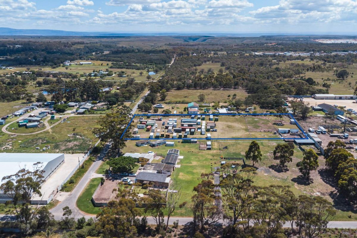 Aerial view of a large vacant residential land parcel with perimeter fencing and surrounding rural landscape.