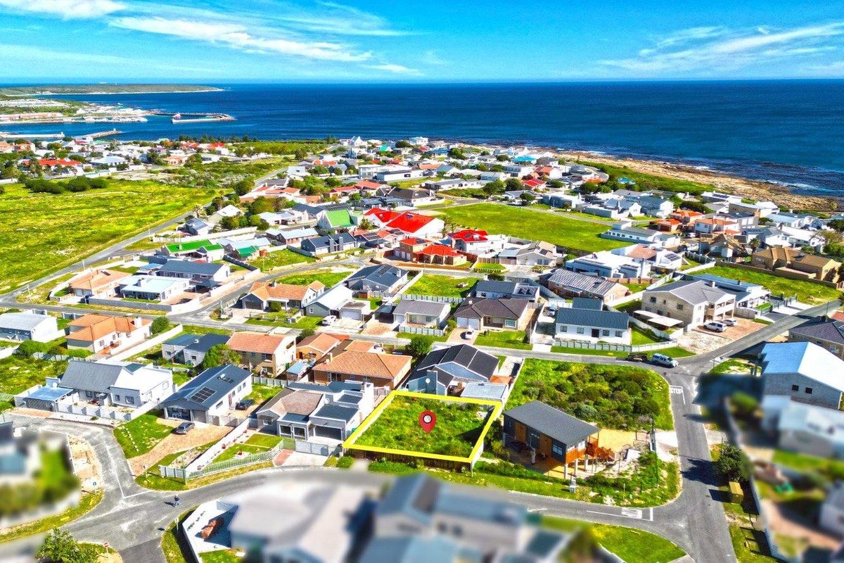 An aerial view of a vacant residential plot situated in a coastal neighborhood, highlighting its location and surrounding community.