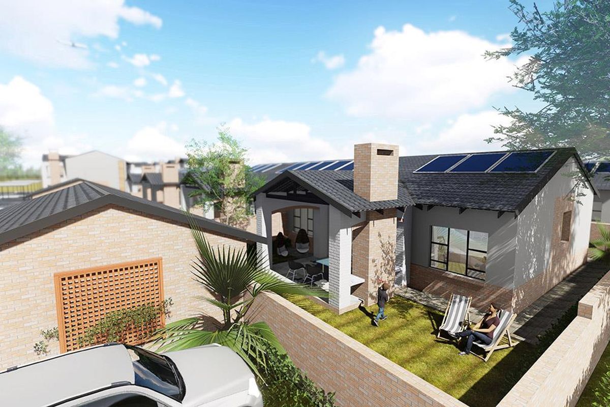 An aerial perspective of a modern residential property featuring a tiled roof, solar panels, a brick chimney, and a covered patio area.