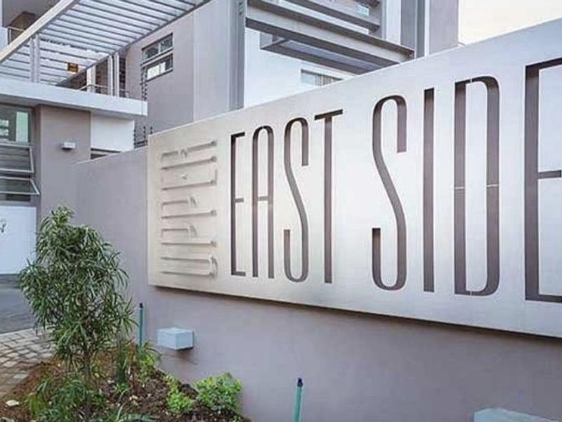 Exterior view of the Upper East Side apartment complex entrance, featuring modern architectural design and clear building signage.