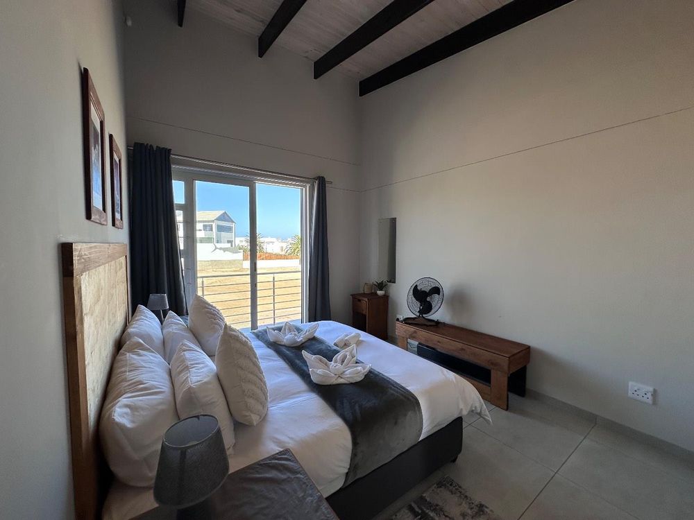 Main Flat, 2 ensuite bedrooms, open plan kitchen with lounge and inside barbecue and balcony.