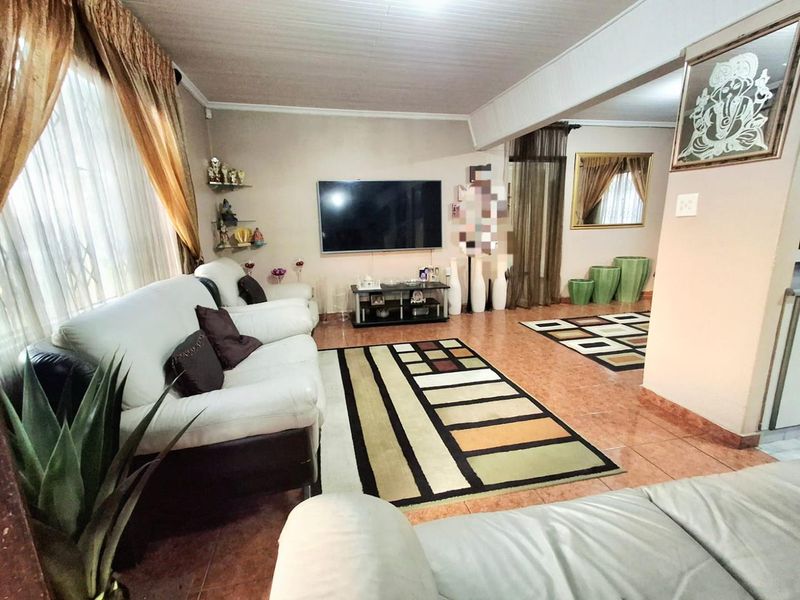 Spacious living area featuring tiled flooring and a tongue and groove ceiling, providing a comfortable and functional space for relaxation.