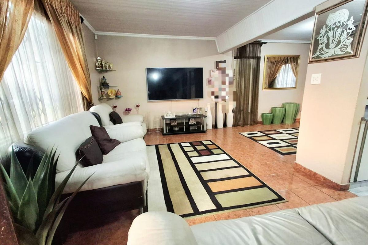 Spacious living area featuring tiled flooring and a tongue and groove ceiling, providing a comfortable and functional space for relaxation.