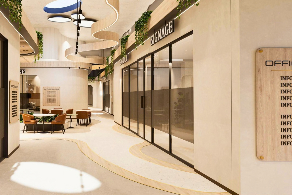 Modern office building hallway featuring curved architectural ceiling details, glass-partitioned office suites, integrated signage, and high-end terrazzo flooring.