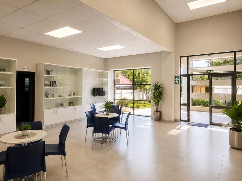 Bright and spacious commercial entrance area featuring tiled flooring, recessed ceiling lights, large glass windows, and built-in display cabinetry.