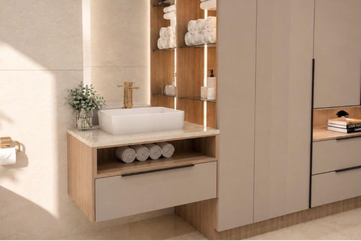 Modern bathroom featuring a floating vanity with a vessel sink, brass fixtures, integrated shelving, and sleek built-in cabinetry with warm accent lighting.