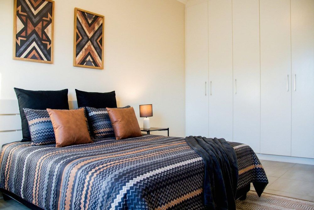 Main bedroom with built-in cupboards and ensuite bathroom.