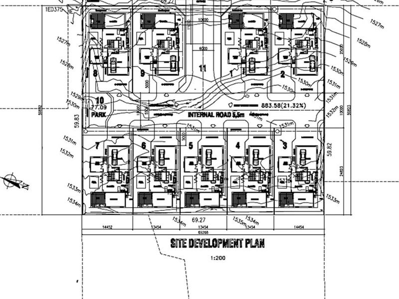 A detailed site development plan showing the layout of residential units, internal roads, and topographical contours for the property.