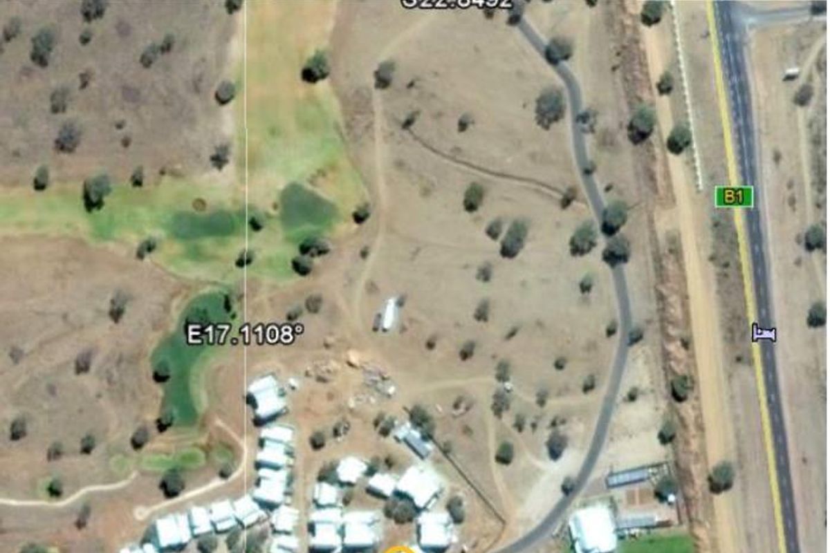 An aerial view showing the property location within the estate, highlighting its proximity to the main road and surrounding landscape.