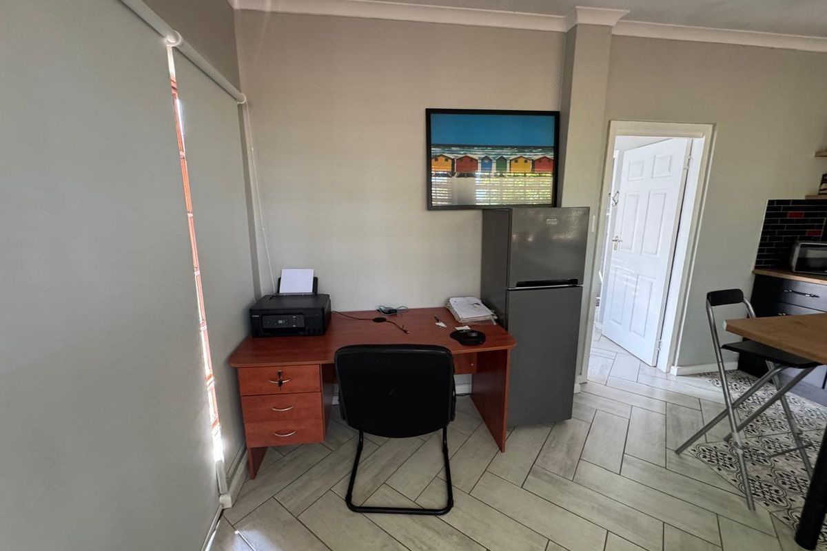 Open plan living area featuring modern herringbone tile flooring, coved ceilings, and neutral wall finishes, providing a versatile space for living or home office use.