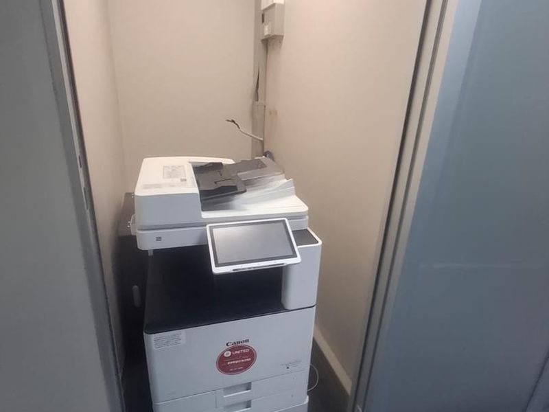 A small utility alcove featuring carpeted flooring and an integrated electrical distribution board, suitable for storage or office equipment.