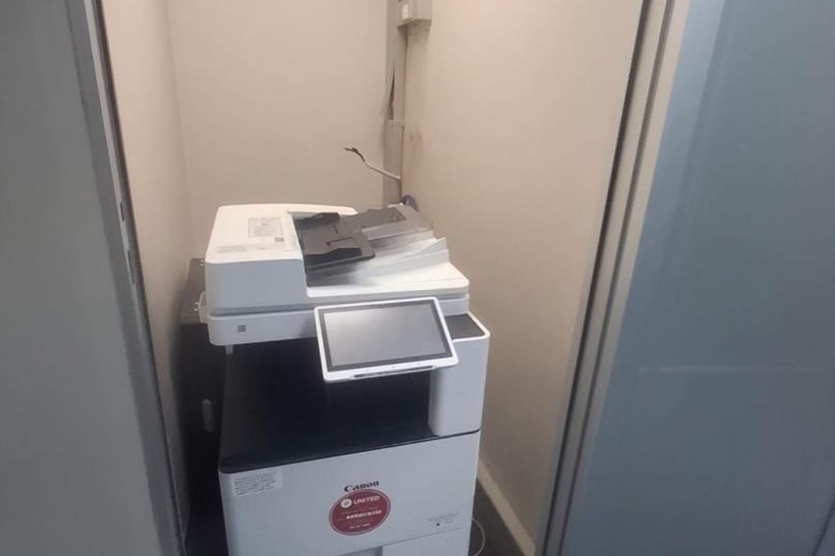 A small utility alcove featuring carpeted flooring and an integrated electrical distribution board, suitable for storage or office equipment.