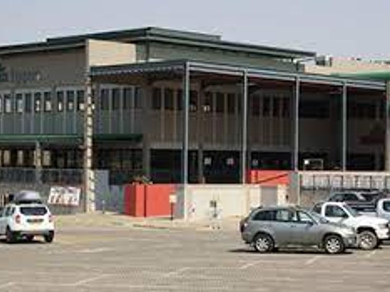 Front exterior view of a commercial retail building featuring a covered patio area and an adjacent paved parking lot.
