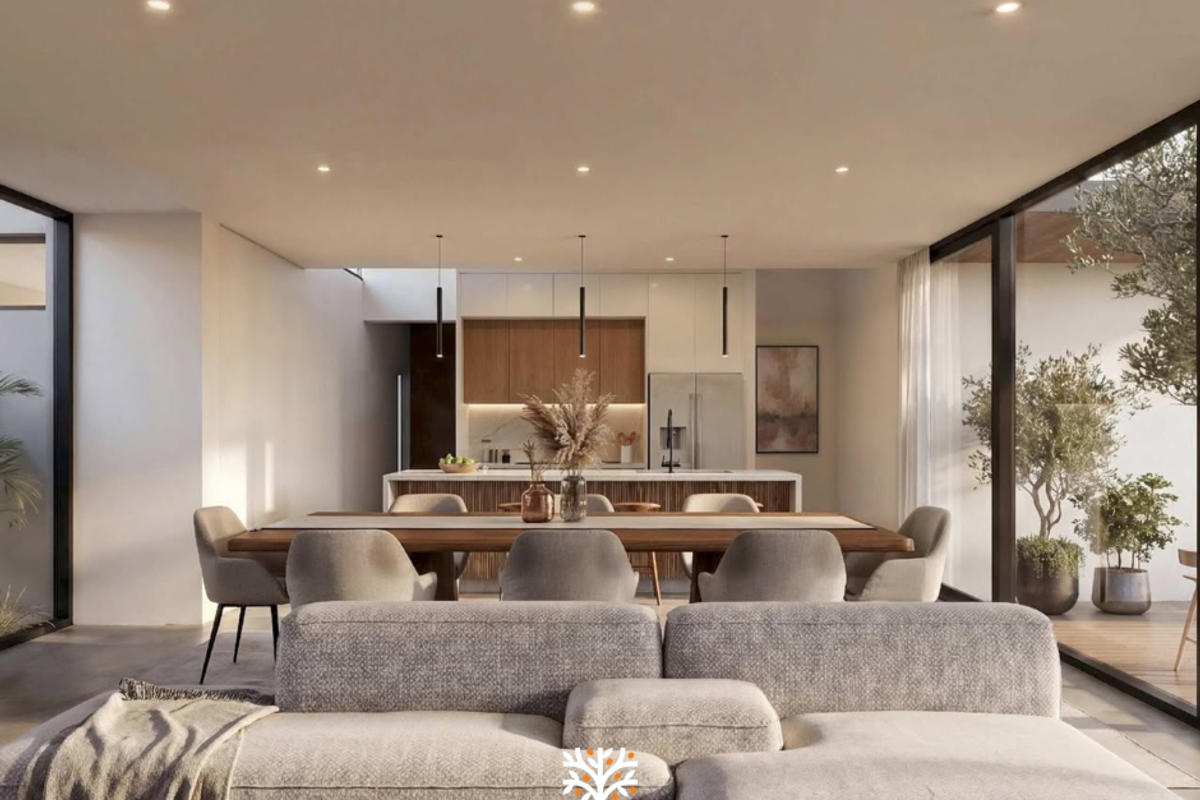 Modern open-plan living and dining area featuring a sleek kitchen with island, recessed lighting, and large sliding glass doors opening to an outdoor space.