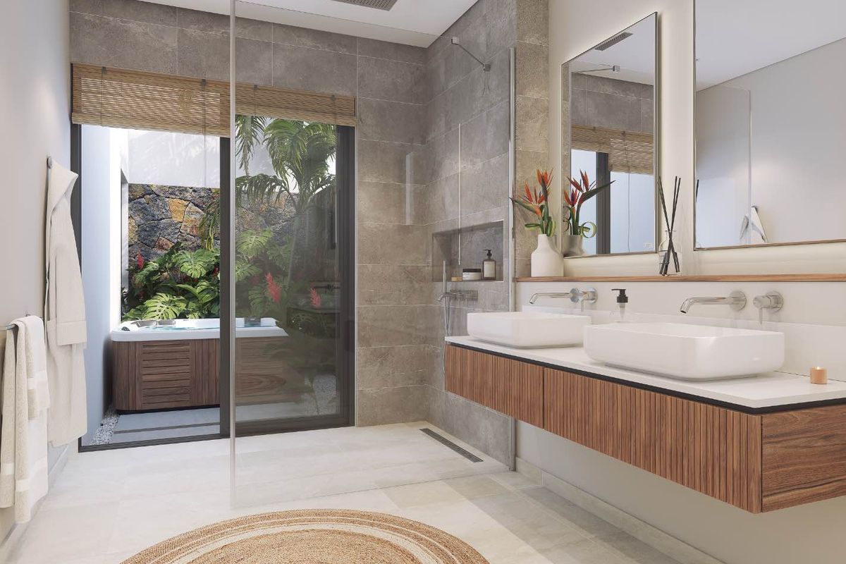 Modern bathroom featuring a floating double vanity, walk-in shower with rainfall head, and direct access to a private outdoor area with a hot tub.