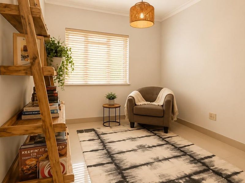 A bright and well-maintained bedroom featuring neutral tiled flooring, clean wall finishes, and natural light through venetian blinds.
