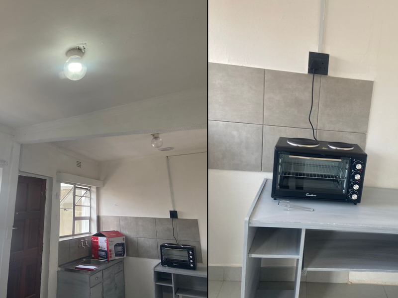 A basic kitchen area featuring a stainless steel sink, tiled splashback, and casement windows, currently requiring cosmetic updates and electrical finishing.
